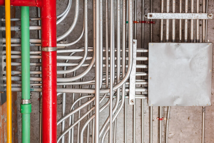 Electrical inside metal tubes on a concrete wall